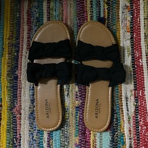 Tan sandals with black bows